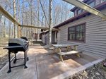 Back patio with picnic table and gas grill 